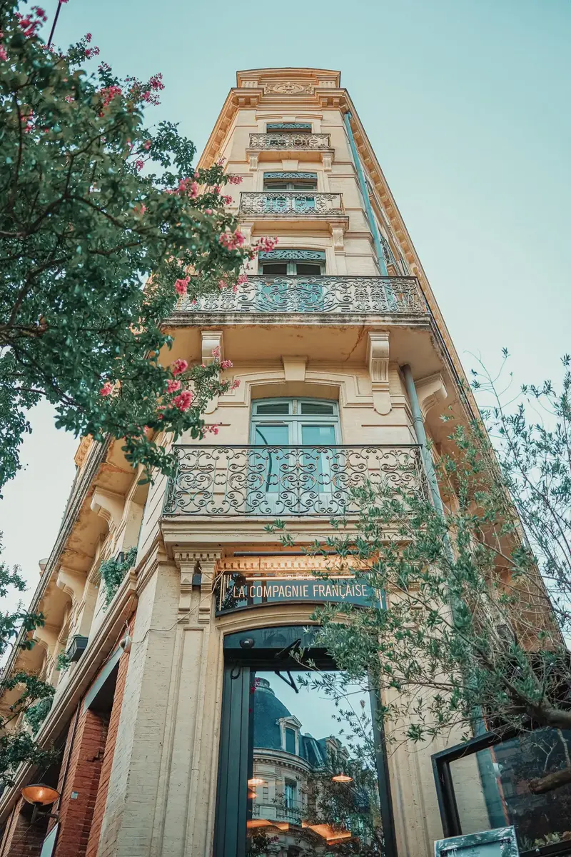 Une façade toulousaine en brique rose sous un ciel clair